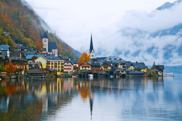 Fototapeta na wymiar Hallstatt town view in a foggy day and clouds between the mountains, Austria.