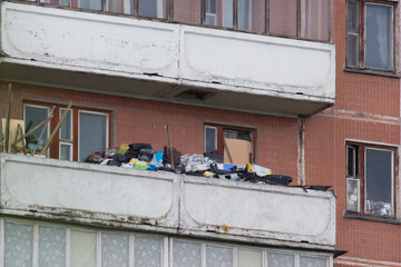 Balcony in the apartment of people who suffers from compulsive hoarding, littered with trash and...