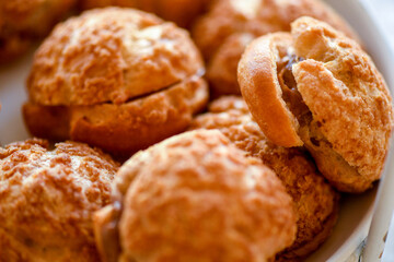 Chocolate choux dessert on a plate, selective focus