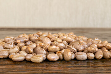 many grains of beans on wooden table