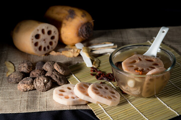 Lotus root soup with beans in a bowl and Chinese herbs, shiitake mushroom, lotus root
