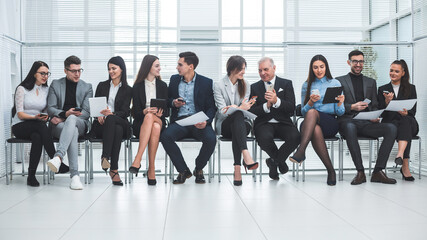group of employees using their devices in the conference room.