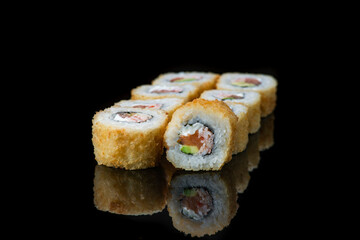 Sushi Roll On A Black Background reflection . Japanese food. Close Up.