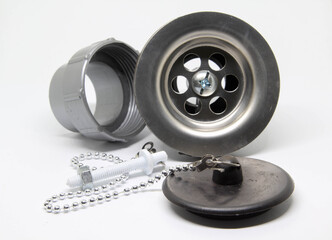 Bath sink plughole set and rubber plug with chain on white background.