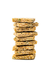 Multigrain Cereal Crunchy Squares Bars with Pumpkin Seeds Background. Healthy Bar Snack on White Background. Selective focus.