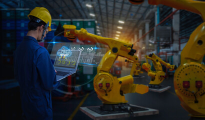 Industry 4.0 Robot concept .Engineers use laptop computers for machine maintenance, automation tools, robot arm at the factory.
