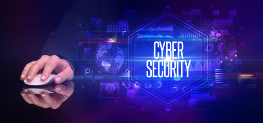 hand holding wireless peripheral with CYBER SECURITY inscription, cyber security concept