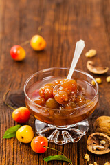 Cherry Jam with Nuts. Azerbaijani Cuisine White Cherry Preserves on Wooden Background. Selective focus.