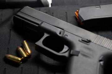 Handgun with bullets on bullet proof vest texture  background