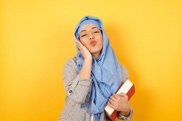 Leisure lifestyle celebrate flirt coquettish concept. Beautiful gorgeous young muslim woman wearing hijab, making v-sign near eyes wearing casual clothes standing against gray wall.