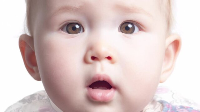 Face transformation of the little girl. Face of the infant baby seven monthes old smoothly transforms into the face of the same baby of one year old