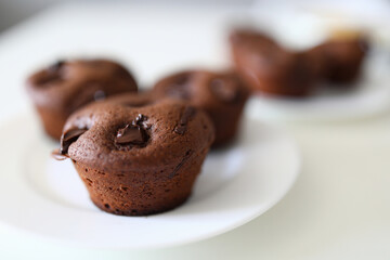 Close up, on white plate are chocolate muffins