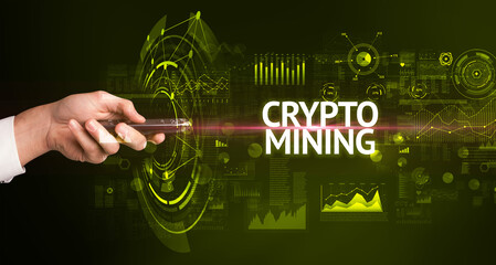 hand holding wireless peripheral with CRYPTO MINING inscription, modern technology concept