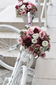 Creative Bouquet Of Colorful Artificial Flowers On Old White Bicycle, Retro. Selective Focus And Space In The Zone Blurring Compositions For The Production Of Advertising And Text.