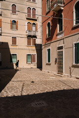One man is walking on the street of Cannaregio district in Venice, Italy.