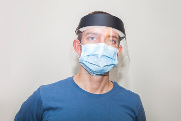 Masked man and protective shield on his head