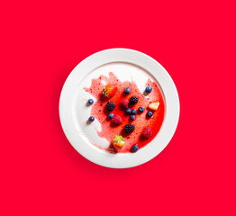 Strawberries and blackberries on defrosted popsicle on white dish