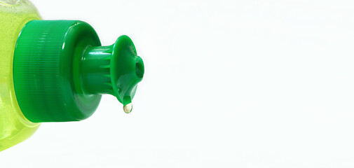 dishwashing liquid. macro shot of green kitchen dish wash bottle Lying Down and a dishwashing liquid drop. closeup. copy space