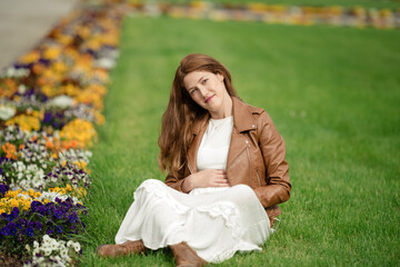 Charming pregnant woman relaxing in the park