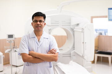 Obraz premium Asian radiologists shows sitting on the chair and the patient CT scan image at display for planing treatment background in x-ray room.High technology for medical treatment equipment concept.