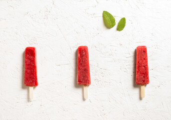 Delicious strawberry popsicles on white background