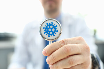 Doctor holds stethoscope infected with coronovirus