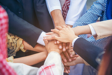 Group of people diversity multiethnic teamwork collaboration team meeting communication  Unified team concept. Business people hands together diversity multiethnic diverse culture partner team meeting - obrazy, fototapety, plakaty