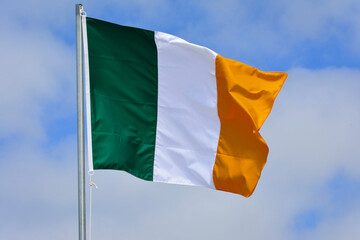 Ireland flag in the wind on the top of the mast