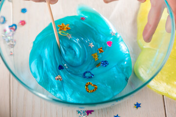 Girl mixing ingredients to make a slime