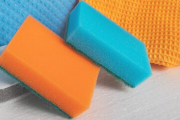Cleaning of apartments, offices, cottages, warehouses, garages. Sponges, rags, brushes on a white background