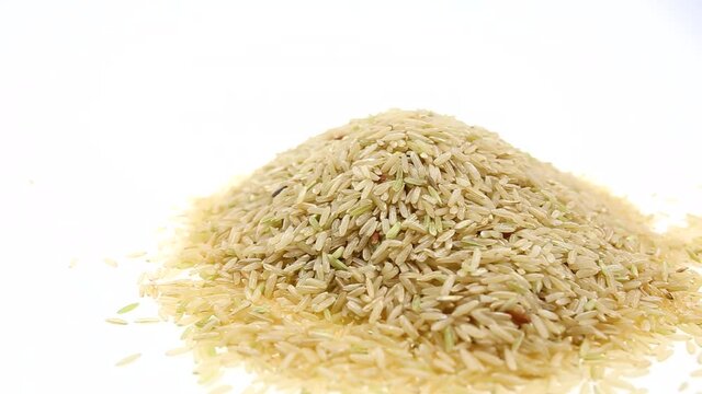 Panning brown rice isolated on white background. On side view.