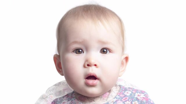 Face transformation of the little girl. Face of the infant baby seven monthes old smoothly transforms into the face of the same baby of one year old