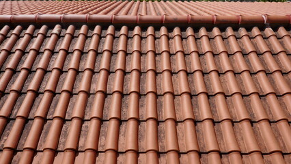New  red tile roof, terra cotta, lightly soiled, close-up
Red tile roof, close-up 

