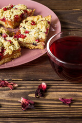 liced ​​homemade grated pie with berries on a pink plate.
