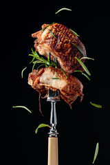 Tasty smoked chicken  with rosemary on a fork.