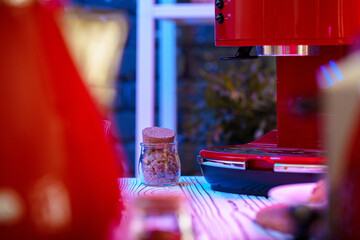 Red coffee machine on kitchen table close up