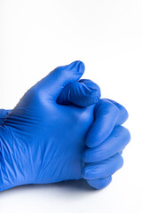 Hands wearing blue latex disposable gloves set on plain white background.