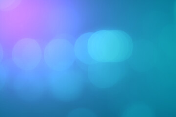 Abstract blurred bokeh on blue gradient background.