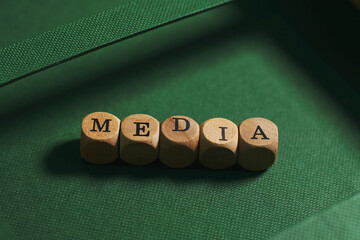 Media word cube on green background ,English language learning concept