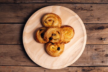 Freshly made homemade pastries on wooden plate overhead view