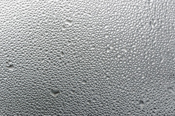 Macro photography of water drops on glass window white background after the rain