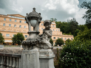 Fototapeta na wymiar Sculpture of the cupid with a lantern in front of Richmond hotel and spa 