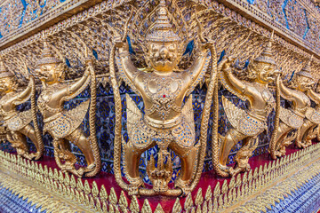 Gilded, ornate demons stand guard at the Grand Palace Bangkok Thailand