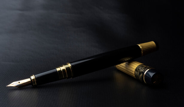 Beautiful Fountain Pen. Under Exposed Photo On A Black Background