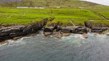 Fototapeta na wymiar Beautiful view of Valentia Island Lighthouse at Cromwell Point. Scenic Irish countyside on sunny summer day, County Kerry, Ireland.