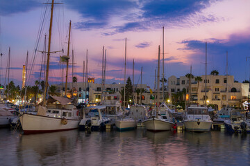 Fototapeta na wymiar Sailboat in harbor at sunset time
