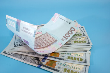 1000 hryvnias to dollars. Business concept. Blue background. Close-up.