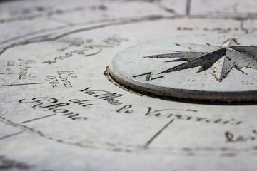 A stone sundial shows the Rhone Valley due north.  - obrazy, fototapety, plakaty