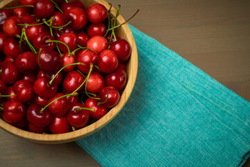 Green spring red cherries on wooden background selective focus cherry