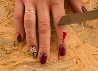 Cut with a stationery knife on the finger with blood stains on the construction site